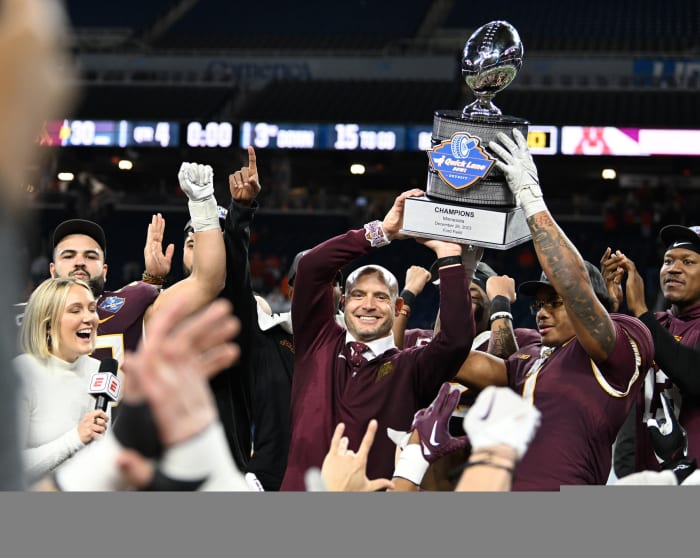 Dec 26, 2023; Detroit, MI, USA; Minnesota Golden Gophers running back Darius Taylor (1) and head coach P.J. Fleck hold up the Quick Lane Bowl trophy after defeating the Bowling Green Falcons at Ford Field.